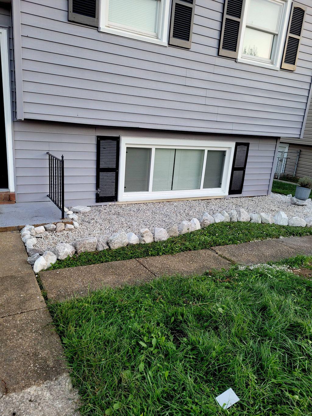 Landscaped side yard with stone edging and lawn